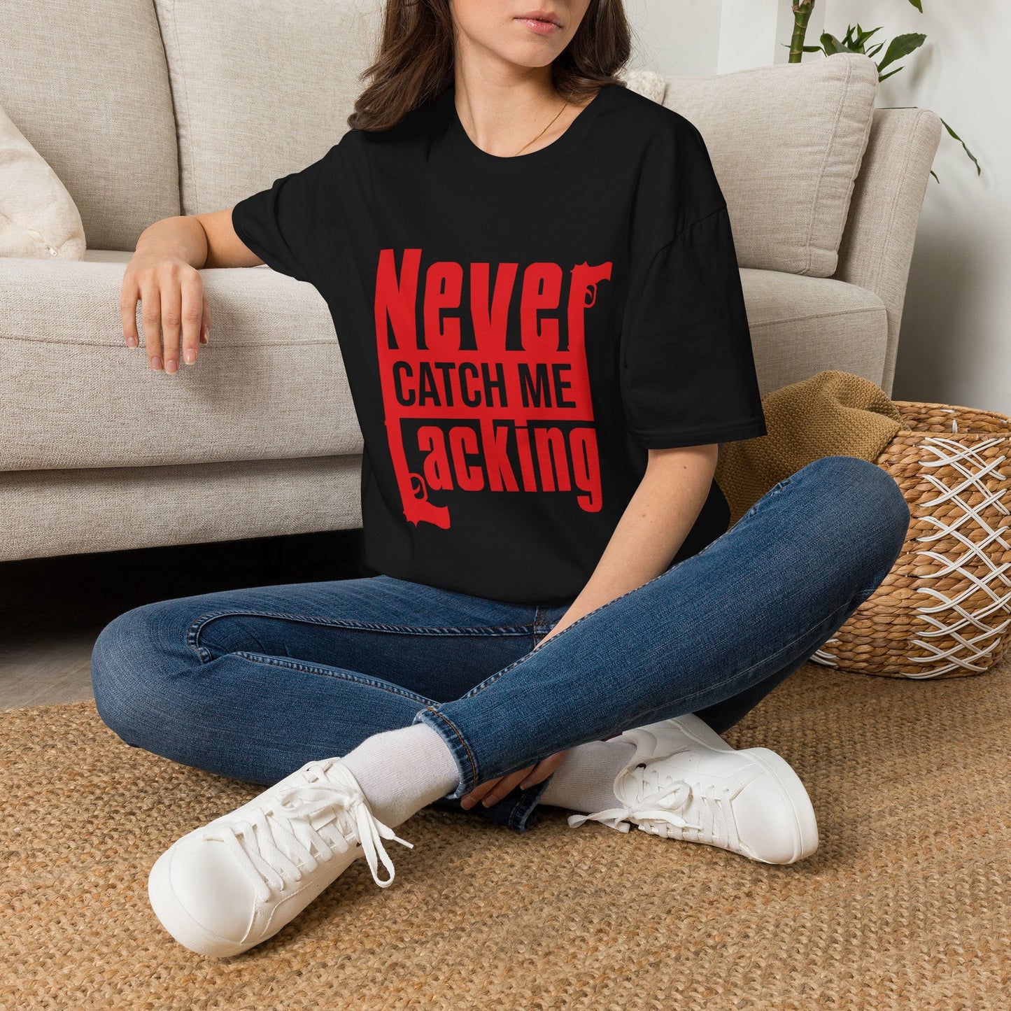 Close-up of the Never Catch Me Lacking design printed on a soft black cotton t-shirt